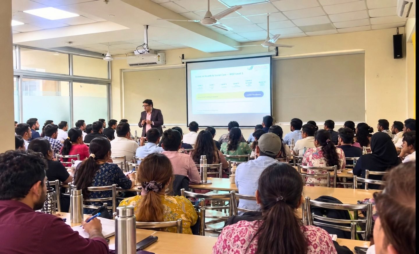 A trainer addressing participants during a classroom presentation