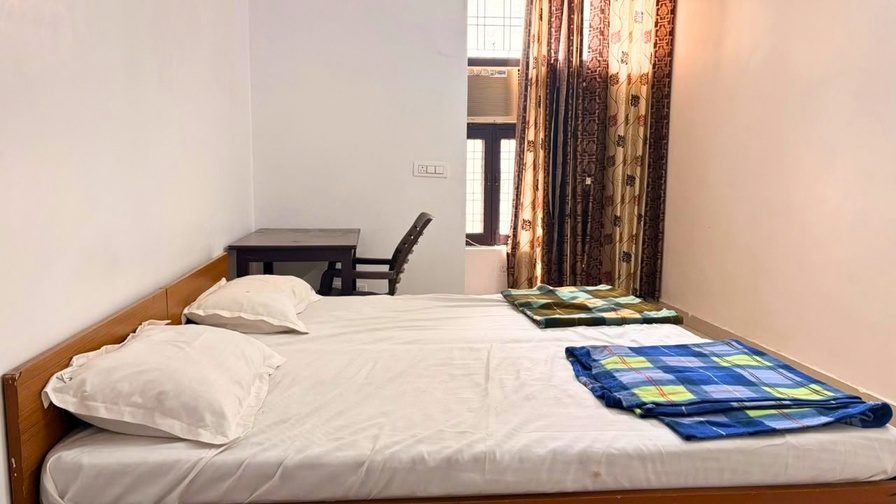 Campus accommodation room with bed and study desk